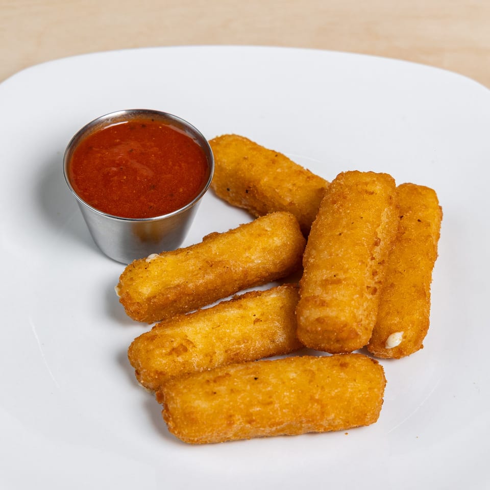 Golden-brown mozzarella sticks and a side of red marinara sauce on a white plate.